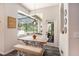 Bright breakfast nook featuring natural light, a wooden table with bench seating, and views of the outdoor space at 5101 Hartwell Loop, Land O Lakes, FL 34638
