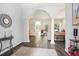 Elegant foyer showcasing wood floors, arched doorways, and neutral paint, leading to the living spaces at 5101 Hartwell Loop, Land O Lakes, FL 34638