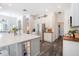 Kitchen with white cabinets, stainless appliances, island with white countertop and gray base at 5101 Hartwell Loop, Land O Lakes, FL 34638