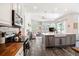 Open concept kitchen with gray cabinets, wood counters and stainless steel appliances at 5101 Hartwell Loop, Land O Lakes, FL 34638