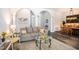 Cozy living room with a comfortable gray sofa, stylish glass coffee table, and open access to the dining area at 5101 Hartwell Loop, Land O Lakes, FL 34638