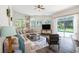 Bright living room with large windows overlooking the pool and a comfortable seating area at 5101 Hartwell Loop, Land O Lakes, FL 34638