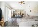 Bright living room with open access to kitchen and sliding glass doors to a covered patio at 5101 Hartwell Loop, Land O Lakes, FL 34638
