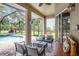 Outdoor living area with comfortable seating, screened-in lanai, and a pool view at 5101 Hartwell Loop, Land O Lakes, FL 34638
