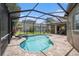 A spacious outdoor area with a pool, hot tub, and screened-in lanai, perfect for entertaining at 5101 Hartwell Loop, Land O Lakes, FL 34638