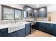 Updated kitchen showcasing blue cabinets, a farmhouse sink, and modern fixtures at 5108 Commonwealth Rd, Palmetto, FL 34221
