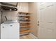 Functional laundry area with shelving and a modern washing machine at 5108 Commonwealth Rd, Palmetto, FL 34221