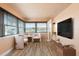 Inviting sitting room with waterfront views, neutral paint, wood floors and TV at 5108 Commonwealth Rd, Palmetto, FL 34221