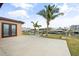 Enjoy waterfront views from this home's patio, featuring palm trees and boat docks nearby at 5108 Commonwealth Rd, Palmetto, FL 34221