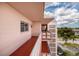 Balcony view showing the walkway, open-air design and exterior view in a neutral color palette at 5623 80Th N St # 504, St Petersburg, FL 33709