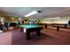 Spacious game room with multiple pool tables and ample lighting, perfect for recreation at 5623 80Th N St # 504, St Petersburg, FL 33709