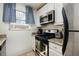 Well-lit kitchen featuring stainless steel appliances and tiled backsplash at 5623 80Th N St # 504, St Petersburg, FL 33709