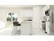Light-filled kitchen with white cabinets, stainless steel appliances, and an island with seating at 5627 Red Kite Dr, Wimauma, FL 33598