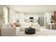 Open-concept living room with white sofa, modern furniture, and a view into the dining area and kitchen at 5627 Red Kite Dr, Wimauma, FL 33598