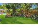 Serene backyard garden featuring lush greenery, mature trees, and inviting wooden benches for relaxation at 5835 29Th N Ave, St Petersburg, FL 33710