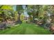 Green backyard featuring lush landscaping, tropical plants and a charming lawn at 5835 29Th N Ave, St Petersburg, FL 33710