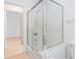 Bathroom featuring a walk-in shower and tub combination, with clean white walls and flooring at 5835 29Th N Ave, St Petersburg, FL 33710