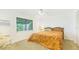 Bright bedroom with large window, ceiling fan, and a comfortable chair at 5835 29Th N Ave, St Petersburg, FL 33710