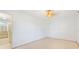 Bright bedroom with a large window and ceiling fan, leading into the ensuite bathroom at 5835 29Th N Ave, St Petersburg, FL 33710