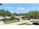 Street view of the home with mature trees in a lush, tropical neighborhood at 5835 29Th N Ave, St Petersburg, FL 33710
