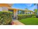 Charming home with a well-manicured lawn, lush hedges, and a welcoming front porch under a clear blue sky at 5835 29Th N Ave, St Petersburg, FL 33710