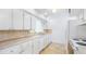 Charming kitchen with white cabinetry, neutral counters, and stainless steel appliances at 5835 29Th N Ave, St Petersburg, FL 33710