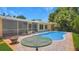 Inviting pool area featuring a sparkling pool, brick patio, screened-in porch, and lush landscaping at 5835 29Th N Ave, St Petersburg, FL 33710