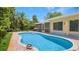 Sparkling pool with brick patio and lush landscaping, perfect for outdoor entertaining and relaxation at 5835 29Th N Ave, St Petersburg, FL 33710