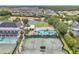 An aerial view of a community center featuring pools, tennis and basketball courts in a beautiful neighborhood at 6212 Nimes Ct, Lutz, FL 33558