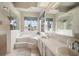 Spacious bathroom with a soaking tub, walk-in shower, dual sinks, and plenty of natural light at 6212 Nimes Ct, Lutz, FL 33558