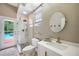 Bright bathroom featuring a walk-in shower, modern sink, and direct access to the outdoor pool area at 6212 Nimes Ct, Lutz, FL 33558