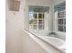 Bright bathroom featuring a soaking tub, tile surround, shower head, and natural light from multiple windows at 6212 Nimes Ct, Lutz, FL 33558