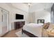 Large bedroom featuring hardwood floors, tray ceiling, and a dresser with TV at 6212 Nimes Ct, Lutz, FL 33558