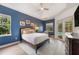 Comfortable bedroom featuring an ensuite bathroom, tray ceiling, light wood floors and access to a pool at 6212 Nimes Ct, Lutz, FL 33558