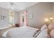 Bright bedroom featuring light walls, wood floors, ceiling fan, and ensuite bathroom at 6212 Nimes Ct, Lutz, FL 33558