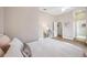 Bedroom with ensuite bathroom, neutral colors, and wood floors, perfect for relaxation at 6212 Nimes Ct, Lutz, FL 33558