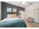 Cozy bedroom with an accent wall, closet, and bright natural light at 6212 Nimes Ct, Lutz, FL 33558