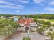 Aerial view of the Tavern and Cheval building featuring a well-manicured landscape and pond at 6212 Nimes Ct, Lutz, FL 33558