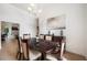 Cozy dining room featuring hardwood floors, stylish lighting, and elegant decor at 6212 Nimes Ct, Lutz, FL 33558