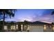 Lovely single-story home featuring a three-car garage, well-maintained landscaping, and exterior lighting at 6212 Nimes Ct, Lutz, FL 33558