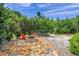 Cozy backyard fire pit area with stone paving and seating, ideal for outdoor gatherings at 6212 Nimes Ct, Lutz, FL 33558