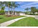 Charming single-story home with a well-manicured lawn, palm trees, and an inviting front entrance at 6212 Nimes Ct, Lutz, FL 33558
