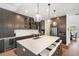 Modern kitchen with stainless appliances, large island with seating, and stylish pendant lights at 6212 Nimes Ct, Lutz, FL 33558
