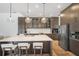 Modern kitchen with a large island, stainless steel appliances, and stylish pendant lighting at 6212 Nimes Ct, Lutz, FL 33558