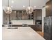 Contemporary kitchen with quartz countertops, stainless steel appliances, and dark cabinetry at 6212 Nimes Ct, Lutz, FL 33558