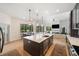 Modern kitchen featuring a center island, stone countertops, and stainless steel appliances at 6212 Nimes Ct, Lutz, FL 33558