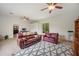 Spacious living room featuring tiled floors, ceiling fans, and views of the outdoors at 6212 Nimes Ct, Lutz, FL 33558
