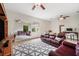 Comfortable living room with ample seating, ceiling fans, and large mirror reflecting the bright interior at 6212 Nimes Ct, Lutz, FL 33558