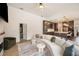 Bright living room featuring a curved couch, hardwood floors, and an open layout to the kitchen at 6212 Nimes Ct, Lutz, FL 33558