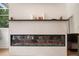 Bright living room with fireplace, mounted television, and a bench seat under a sun-filled window at 6212 Nimes Ct, Lutz, FL 33558